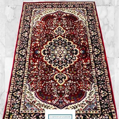 “Handmade Kashmiri style silk rug with central medallion design laid flat”